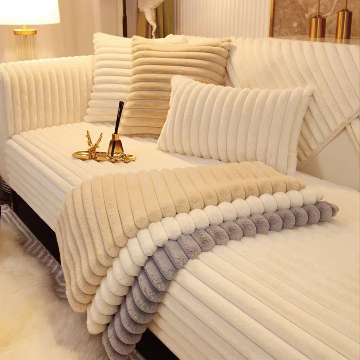 Cream ribbed sofa pads and cushions in a warm living room